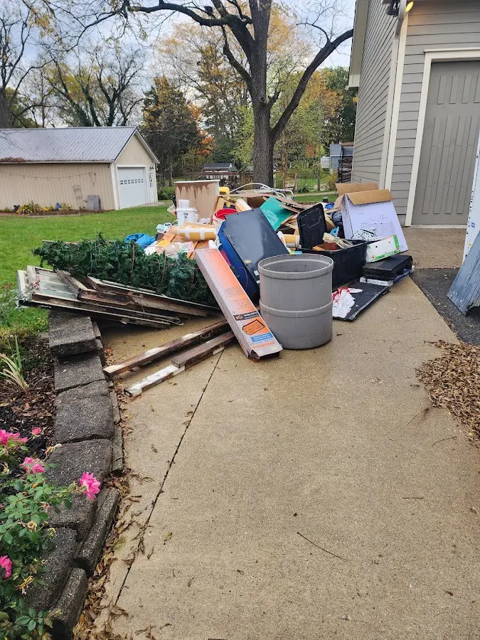 Dumpster being loaded with debris for Estate Cleanout Dumpster Rental in Corinth